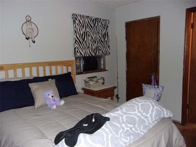 bedroom with hardwood / wood-style flooring