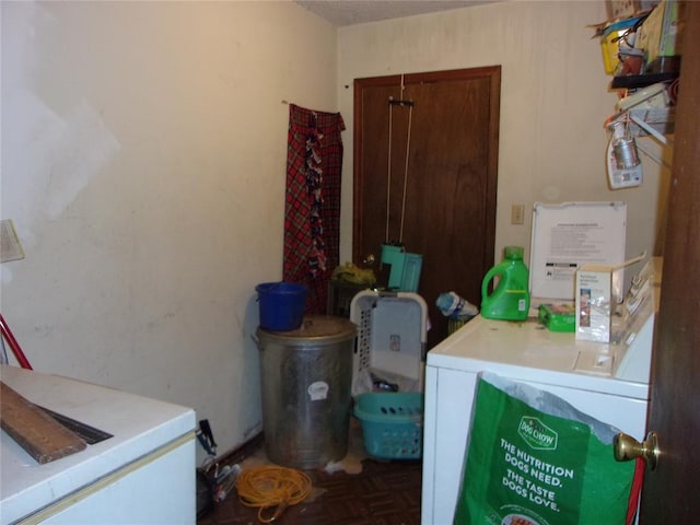 washroom with parquet flooring and washer and clothes dryer