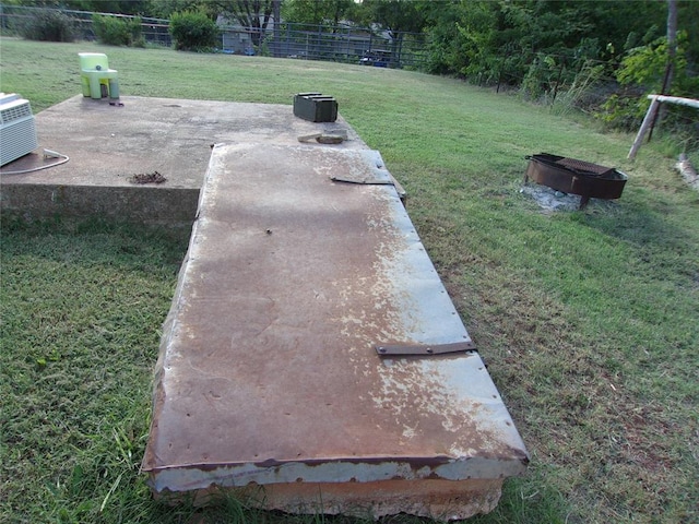 view of storm shelter with a yard