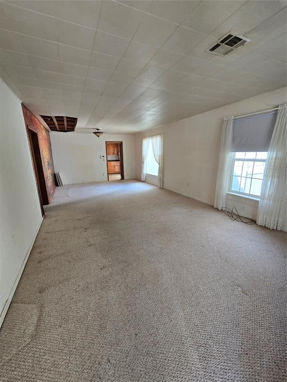 spare room featuring light colored carpet