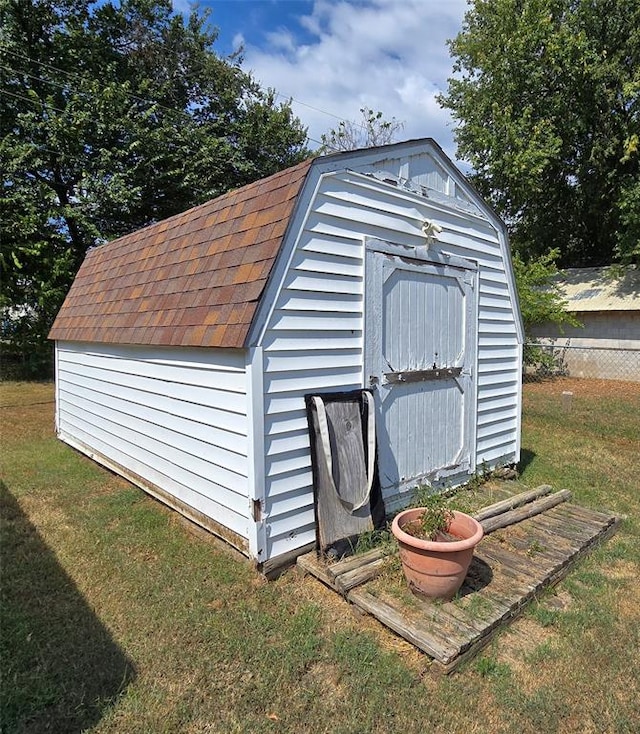 view of outbuilding with a yard