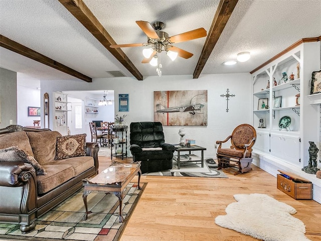 living room featuring hardwood / wood-style floors, ceiling fan, beam ceiling, and a textured ceiling