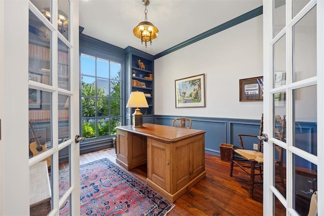 home office with dark hardwood / wood-style flooring, ornamental molding, and french doors