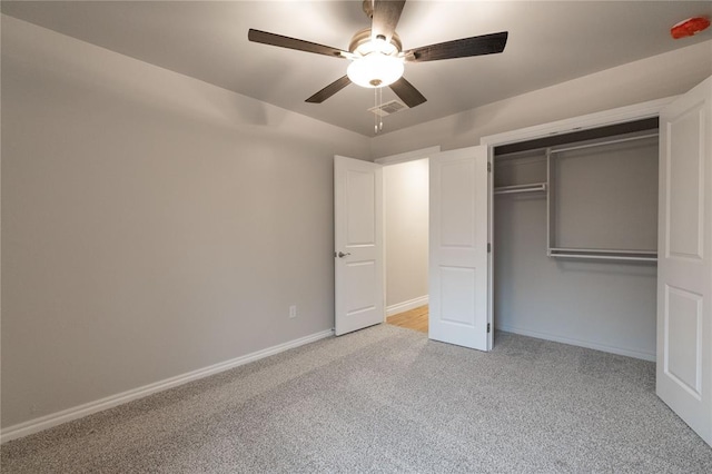 unfurnished bedroom with a closet, light colored carpet, visible vents, a ceiling fan, and baseboards