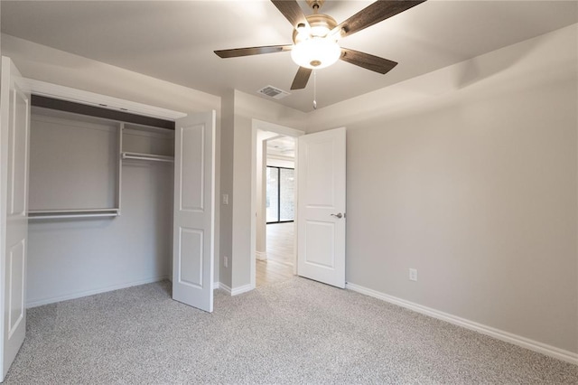 unfurnished bedroom featuring a closet, carpet flooring, visible vents, and baseboards