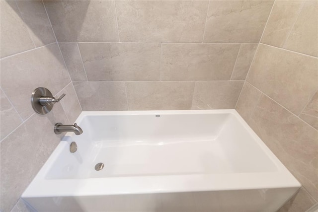 bathroom with a tub and a shower