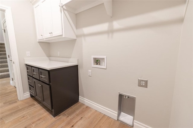 laundry room with light wood finished floors, washer hookup, cabinet space, and electric dryer hookup