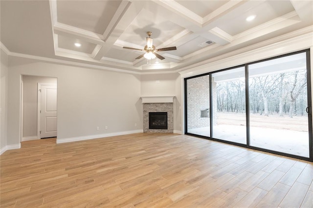 unfurnished living room with a fireplace, coffered ceiling, baseboards, ornamental molding, and light wood-type flooring