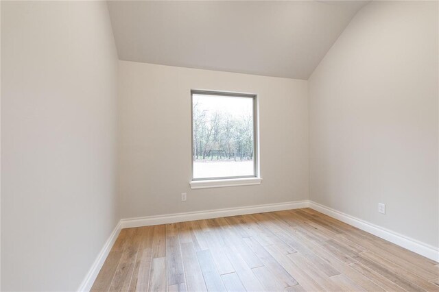 14109 Birch Ln, Edmond, OK 73049 - empty room featuring light wood-style flooring, baseboards, and vaulted ceiling