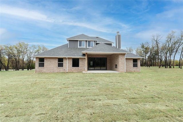 14109 Birch Ln, Edmond, OK 73049 - rear view of house with a lawn, roof with shingles, a patio area, brick siding, and a chimney
