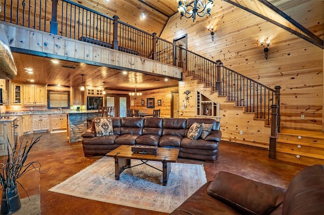 living room with beam ceiling, high vaulted ceiling, a notable chandelier, wooden walls, and wood ceiling