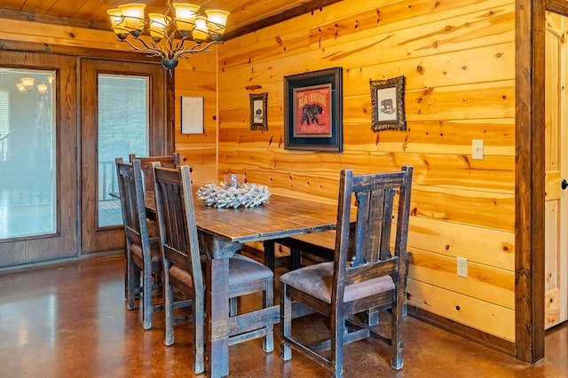 dining space with wooden ceiling, wooden walls, and an inviting chandelier