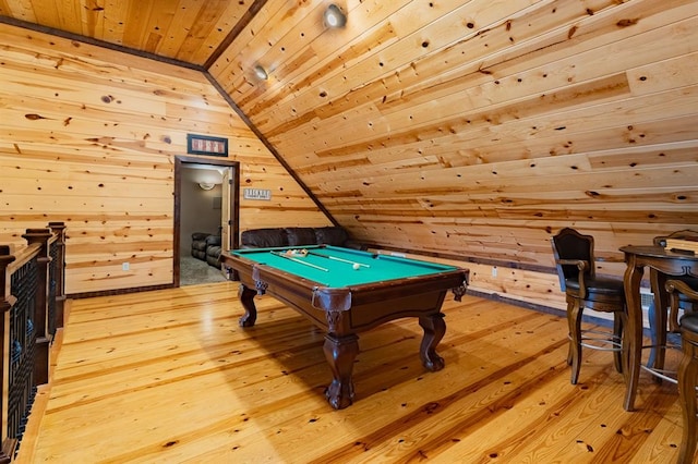 recreation room with light hardwood / wood-style floors, vaulted ceiling, wooden walls, and pool table