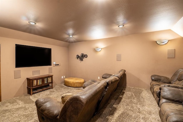 home theater with carpet flooring, a textured ceiling, and vaulted ceiling