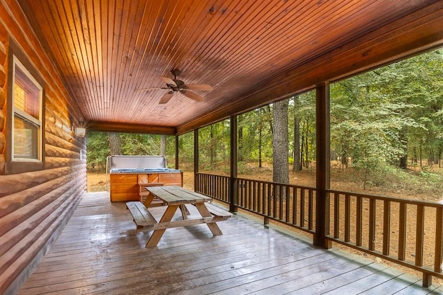 unfurnished sunroom with ceiling fan and wood ceiling