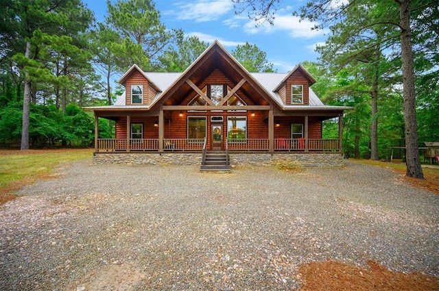 143 Honey Crisp Ln, Broken Bow, OK 74728 - view of front of home featuring a porch, gravel driveway, and log veneer siding