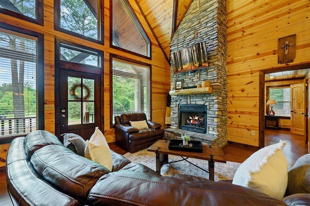 143 Honey Crisp Ln, Broken Bow, OK 74728 - living room featuring wood finished floors, wood ceiling with exposed beams, wood walls, a stone fireplace, and high vaulted ceiling