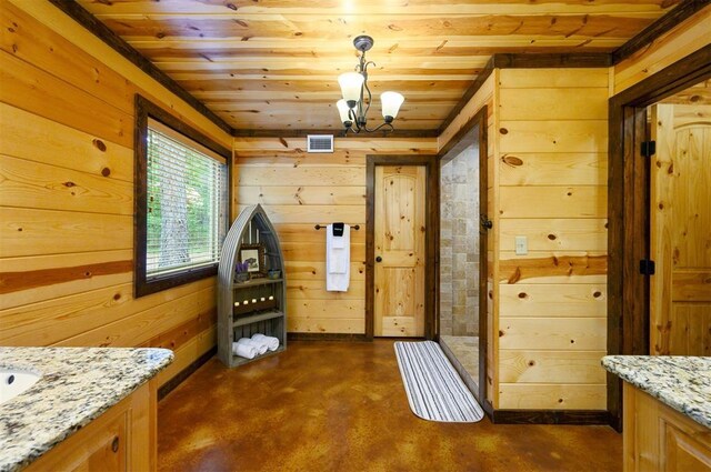 143 Honey Crisp Ln, Broken Bow, OK 74728 - dining space with wooden ceiling, finished concrete floors, wooden walls, and a chandelier