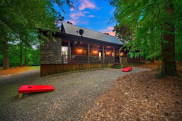 143 Honey Crisp Ln, Broken Bow, OK 74728 - back of house at dusk with metal roof