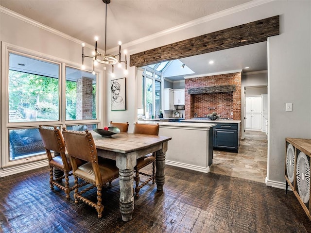 dining room featuring a notable chandelier, a healthy amount of sunlight, and ornamental molding