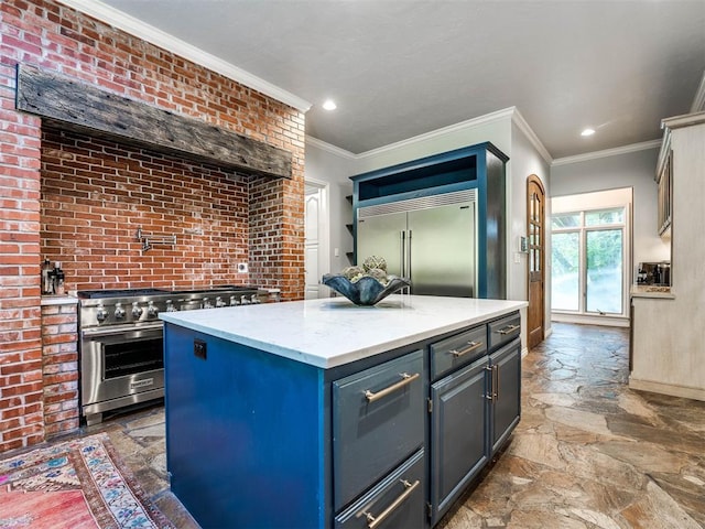 kitchen with a center island, high end appliances, light stone counters, and brick wall