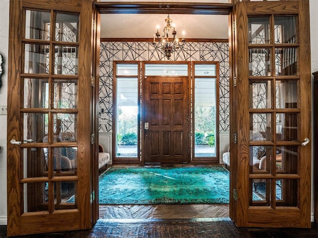 foyer featuring plenty of natural light and a notable chandelier