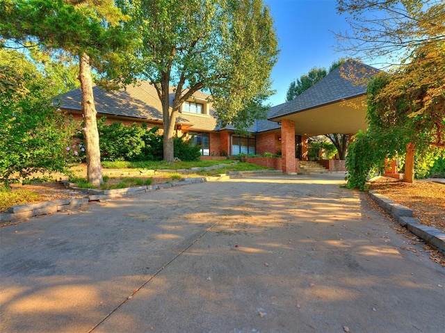 view of front of property with driveway and brick siding