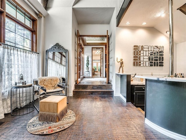 interior space featuring high vaulted ceiling, recessed lighting, and baseboards