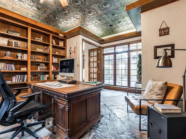 home office featuring a textured wall, built in shelves, stone tile floors, an ornate ceiling, and crown molding