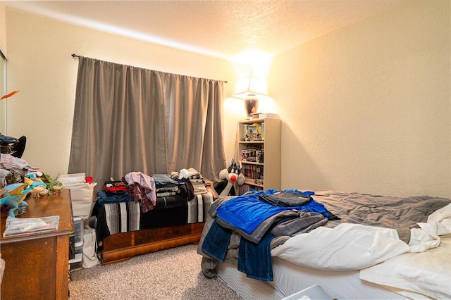 bedroom featuring a textured ceiling and light colored carpet