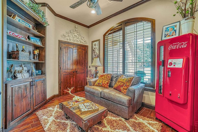 living room with dark hardwood / wood-style floors, ceiling fan, and crown molding