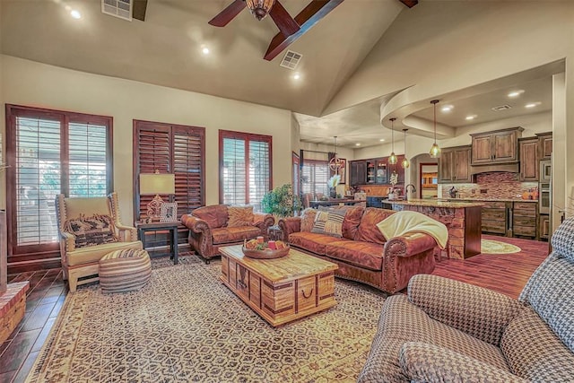 living room with ceiling fan, high vaulted ceiling, and light tile patterned flooring