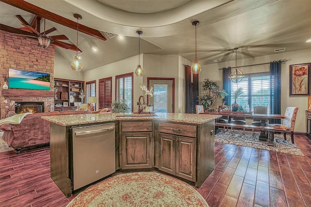 kitchen featuring dishwasher, dark hardwood / wood-style flooring, hanging light fixtures, and a kitchen island with sink