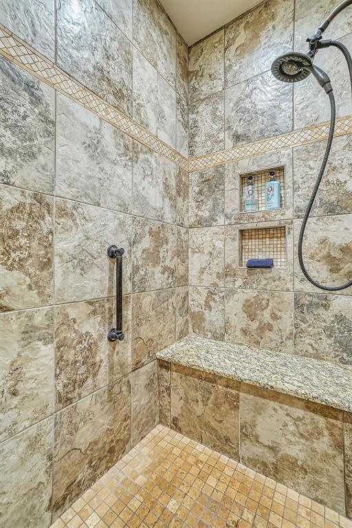 bathroom with tiled shower