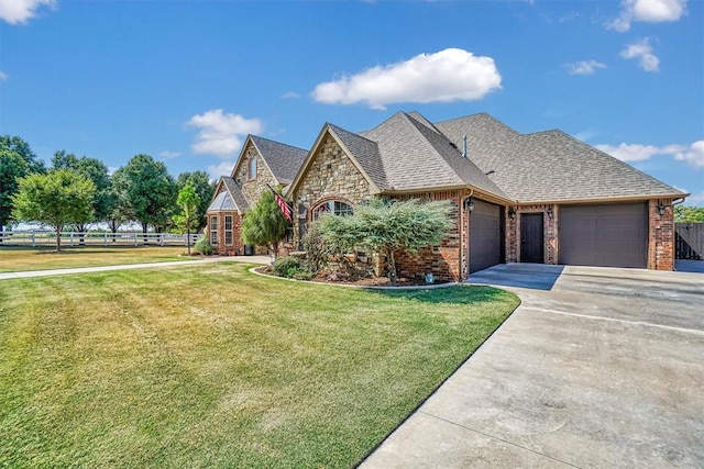 view of front of home with a front yard and a garage