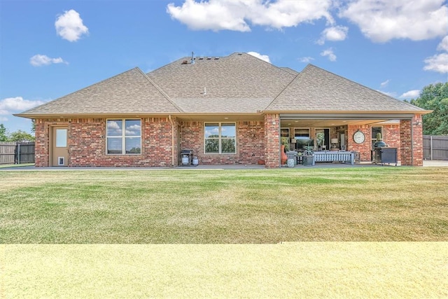 back of house with a lawn