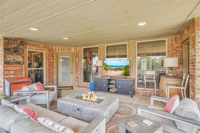 view of patio featuring an outdoor living space with a fire pit