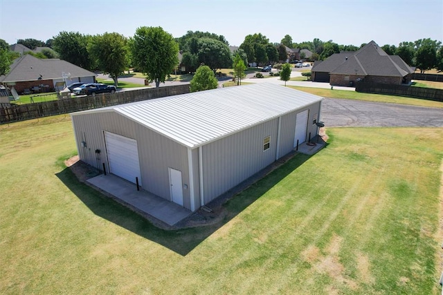 view of outbuilding with a lawn and a garage