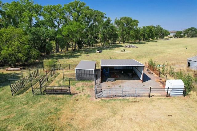 view of yard with a rural view and an outdoor structure