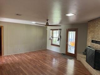 1305 SE 15th St, Wagoner, OK 74467 - unfurnished living room with a brick fireplace, wood finished floors, and baseboards