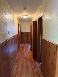 1305 SE 15th St, Wagoner, OK 74467 - corridor featuring a wainscoted wall, wood walls, and dark wood-style flooring