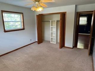 1305 SE 15th St, Wagoner, OK 74467 - unfurnished bedroom featuring light colored carpet, a closet, baseboards, and ceiling fan