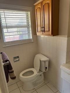 1305 SE 15th St, Wagoner, OK 74467 - bathroom with toilet, tile patterned floors, vanity, and a wainscoted wall