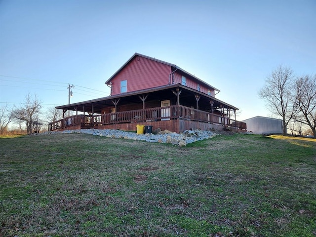 back of house with an outdoor structure and a yard