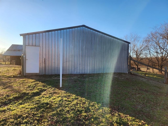 view of outbuilding featuring a yard