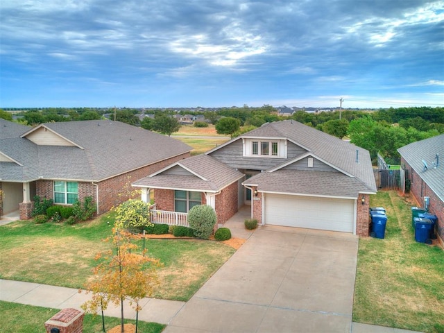 view of front of property with a front yard, a garage, and covered porch