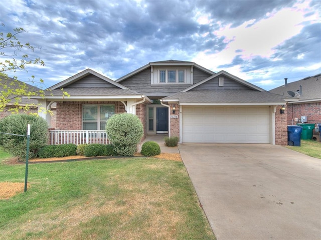 view of front of house featuring a front yard, a garage, and covered porch