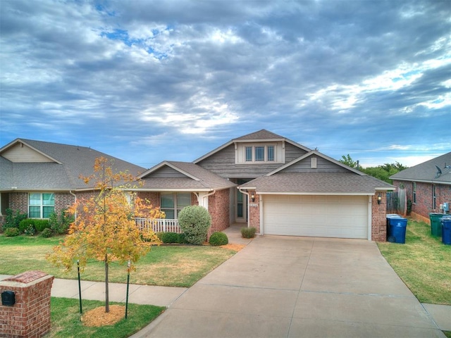 view of front of home with a front lawn, covered porch, and a garage