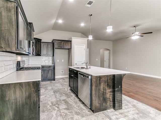 kitchen with sink, stainless steel dishwasher, an island with sink, decorative light fixtures, and light wood-type flooring