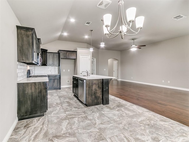 kitchen featuring light hardwood / wood-style flooring, stainless steel dishwasher, pendant lighting, a center island with sink, and ceiling fan with notable chandelier